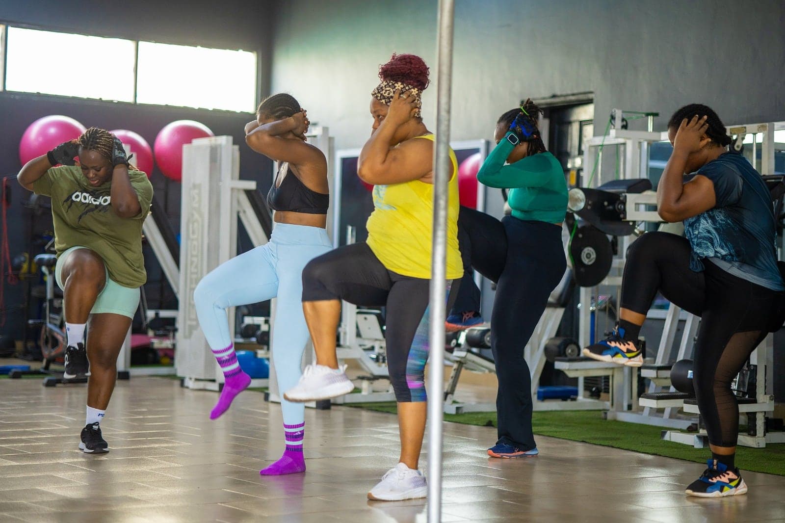 A group fitness session taking place on the Fit & Fine gym floor