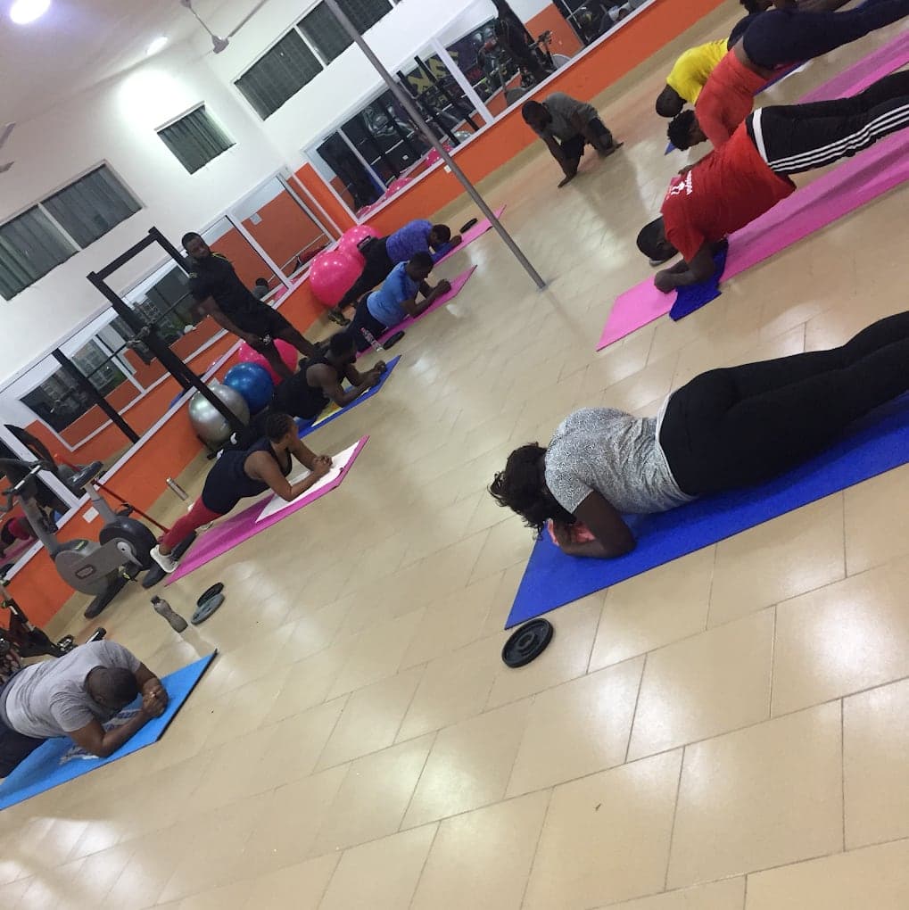 Members exercising on mats in the Fit & Fine group training area